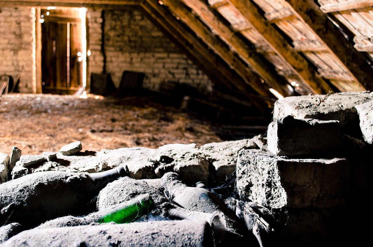 Debris and old material on the floor of a dim attic